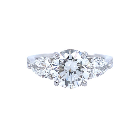 Platinum and round diamond ring with pear shaped side diamonds