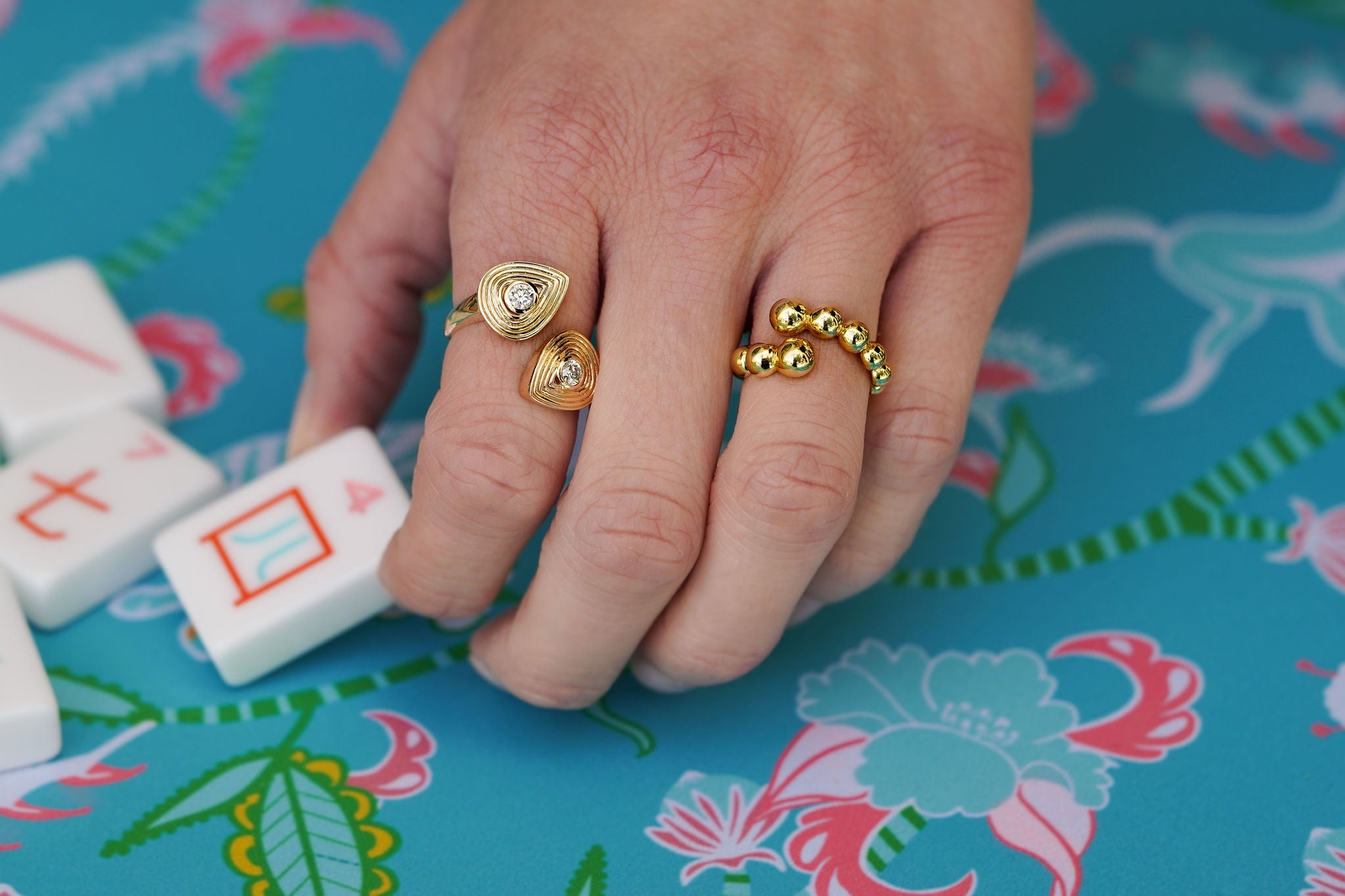woman wearing gold fashion rings curated by Laura Pearce