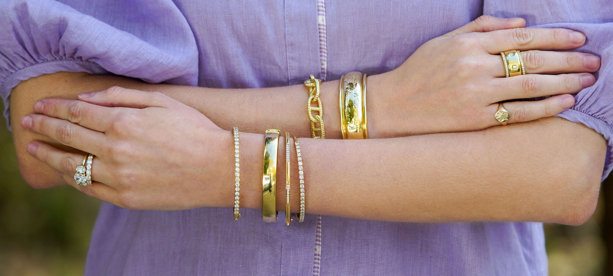 Woman wearing Fine Jewelry 18K bracelets and diamond rings