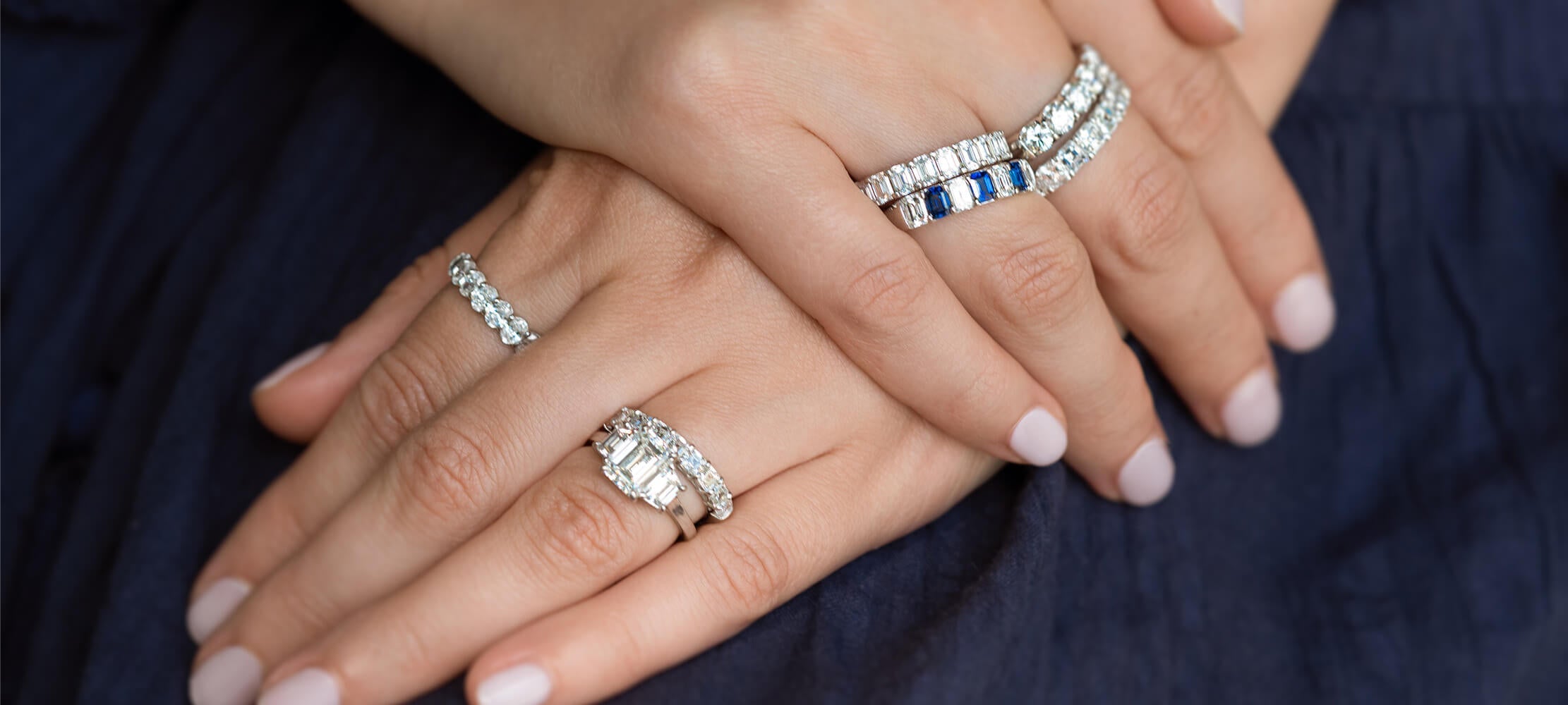 woman wearing multiple gold diamond and sapphire rings