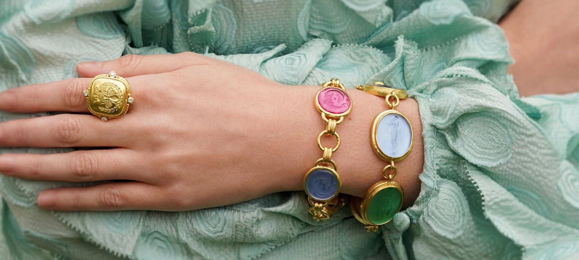 Woman wearing bracelets and a ring from the Elizabeth Locke Collection