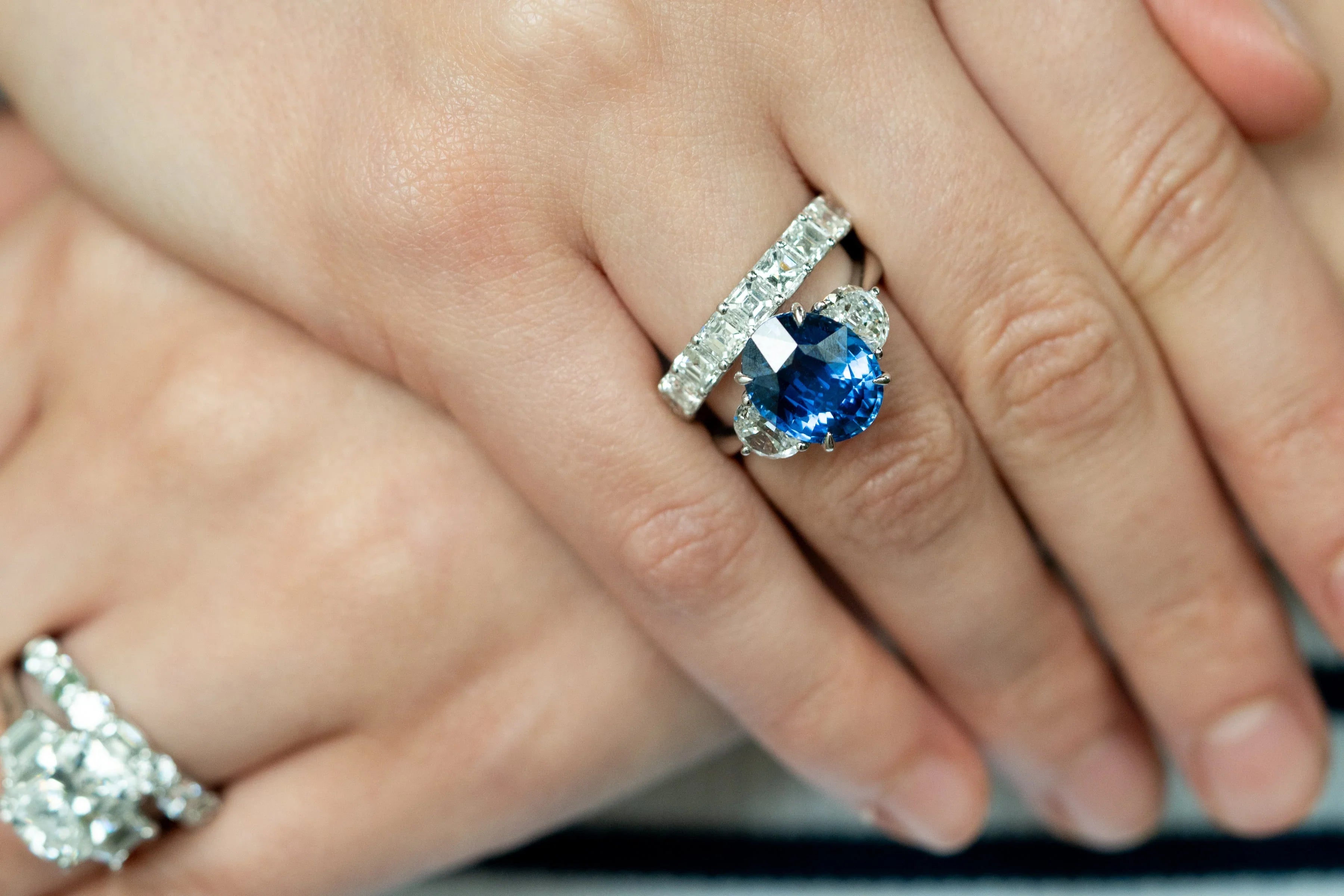 woman wearing sapphire and diamond rings