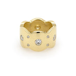 An 18K yellow gold band ring with multiple flush set diamonds