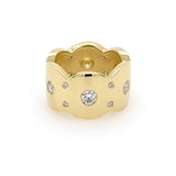 An 18K yellow gold band ring with multiple flush set diamonds