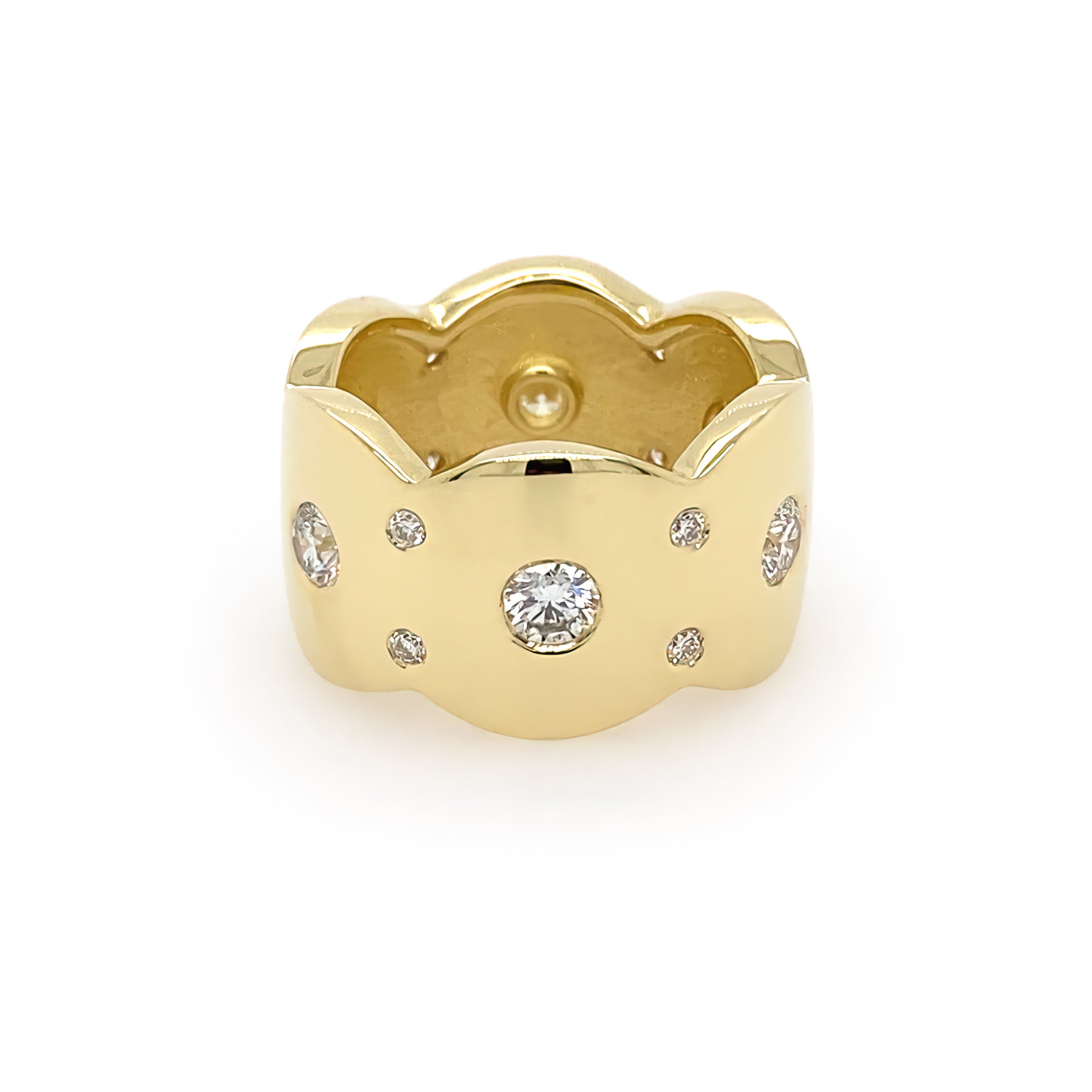 An 18K yellow gold band ring with multiple flush set diamonds
