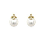 Pair of pearl earrings with gold and diamond butterfly-shaped tops on a white background