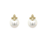 Pair of pearl earrings with gold and diamond butterfly-shaped tops on a white background