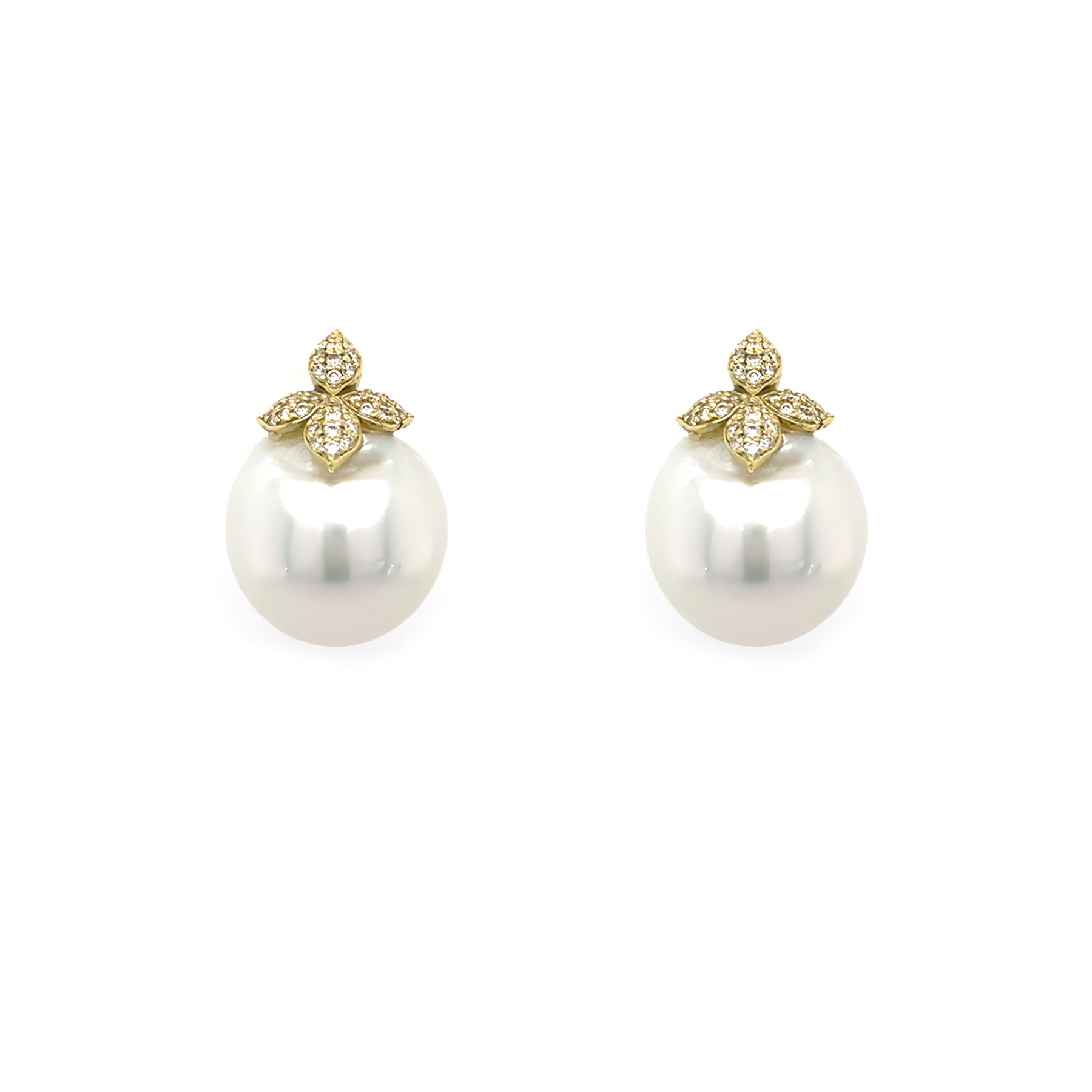 Pair of pearl earrings with gold and diamond butterfly-shaped tops on a white background