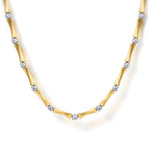A 14K yellow gold necklace with a bamboo-inspired segmented design, accented with small round clear diamonds at intervals, shown on a clean white background.