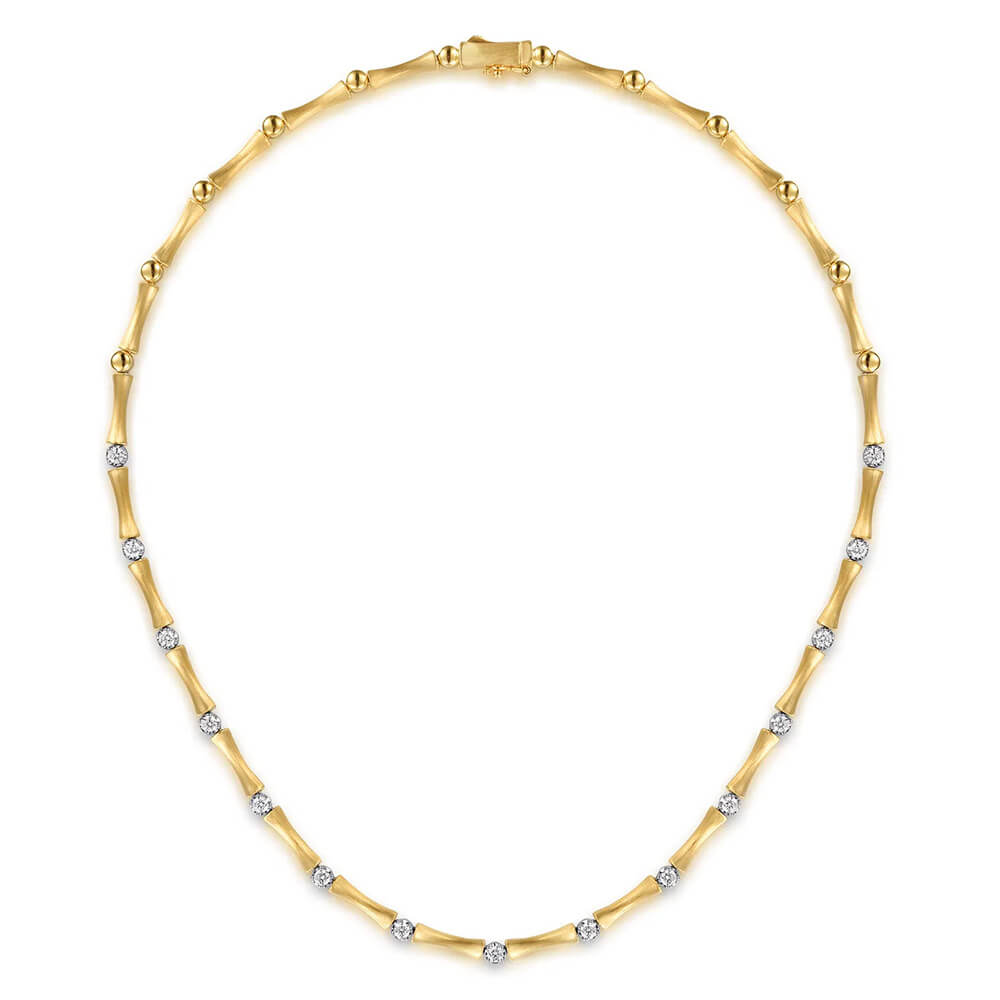 A 14K yellow gold tennis necklace featuring small round-cut diamonds set along the chain, displayed on a clean white background.