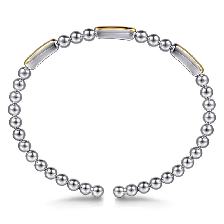 Bracelet with sterling silver beads and 14k gold bars on a white background
