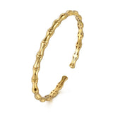 A 14K gold bamboo-style cuff bracelet with a polished finish and open back, shown on a plain white background.