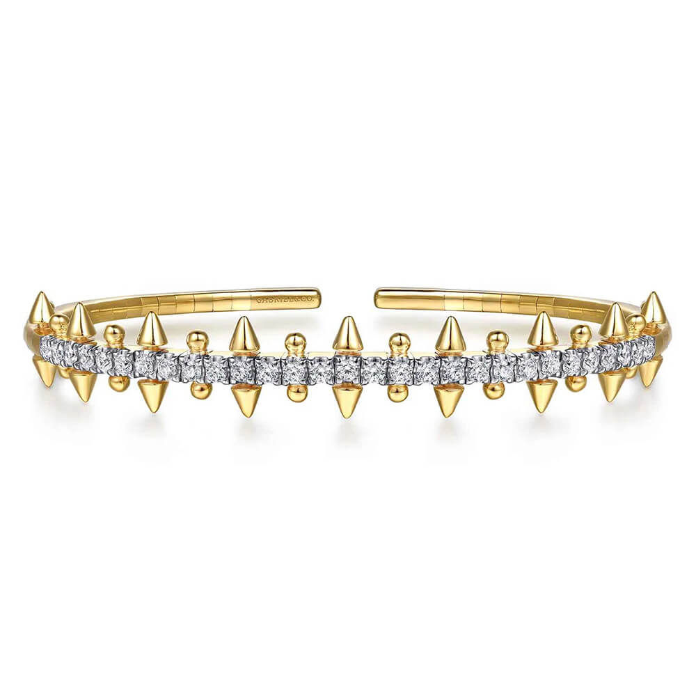 A 14K yellow gold cuff bracelet featuring a central row of clear pavé-set diamonds and multiple pointed spike accents on both sides, shown on a plain white background.