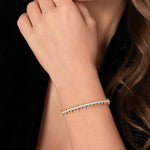 A 14K yellow gold cuff bracelet featuring a central row of clear pavé-set diamonds and multiple pointed spike accents on both sides, shown on a plain white background.