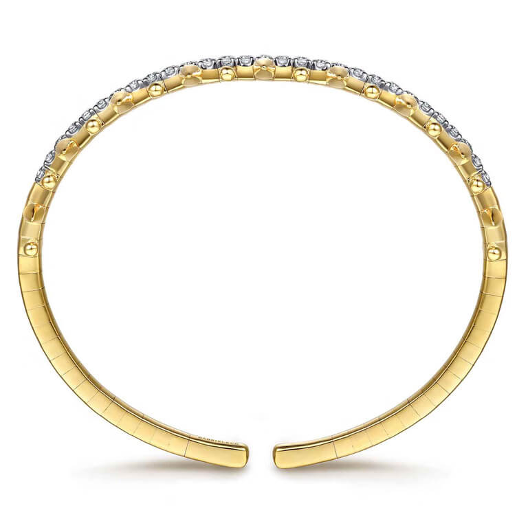 A 14k Yellow Gold open cuff bracelet featuring a row of clear diamonds along the top curve, set against a plain white background.
