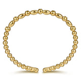A 14K gold beaded bracelet with alternating smooth oval beads and smaller round beads, displayed on a clean white background.