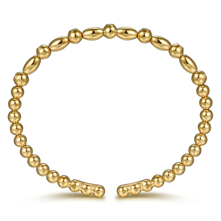 A 14K gold beaded bracelet with alternating smooth oval beads and smaller round beads, displayed on a clean white background.