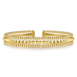 A 14K gold cuff bracelet featuring multiple rows of polished Bujukan beads and pyramid-shaped textured details, displayed on a clean white background.