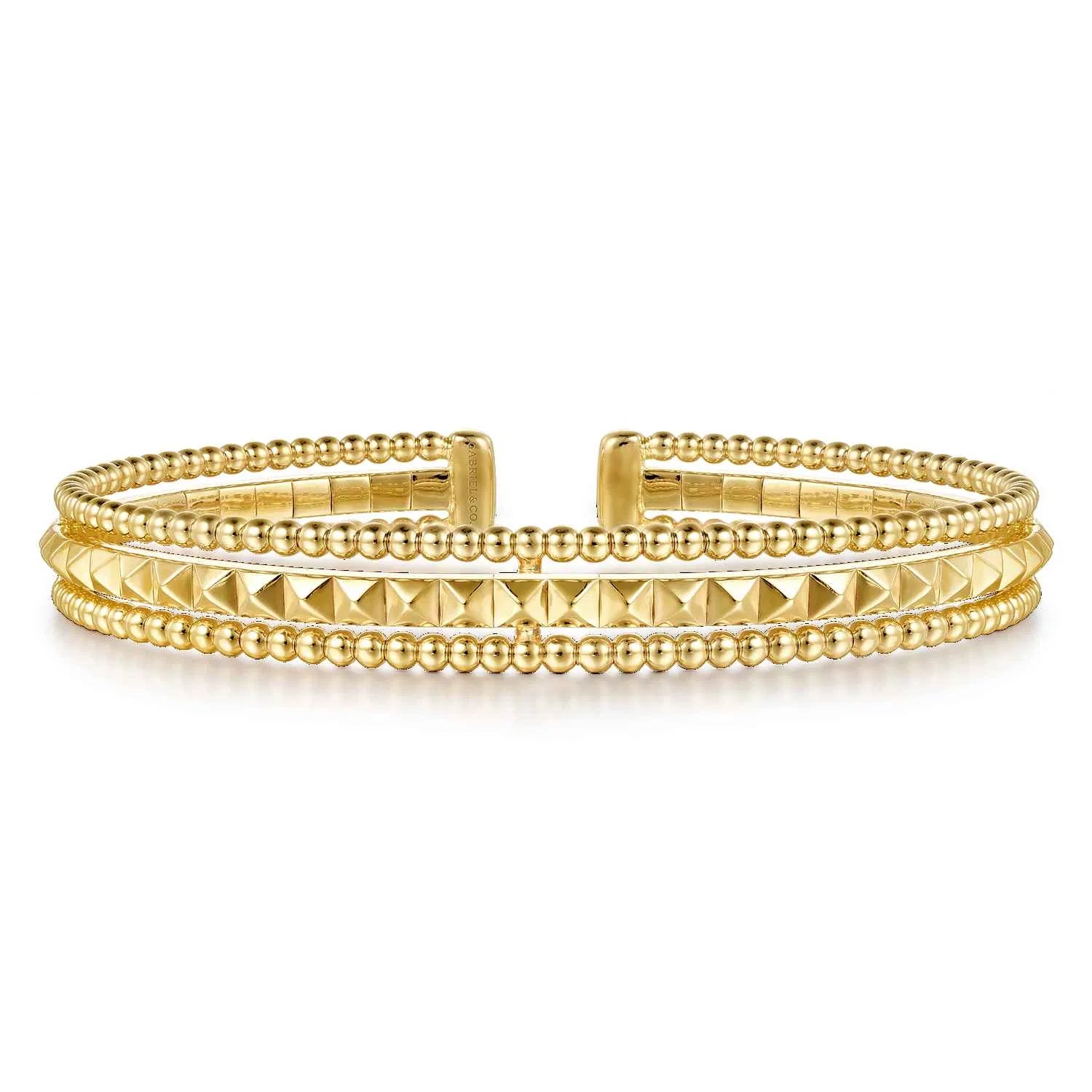 A 14K gold cuff bracelet featuring multiple rows of polished Bujukan beads and pyramid-shaped textured details, displayed on a clean white background.