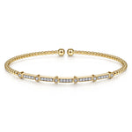 Gold bracelet with diamond accents on a white background