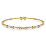 Gold bracelet with diamond accents on a white background