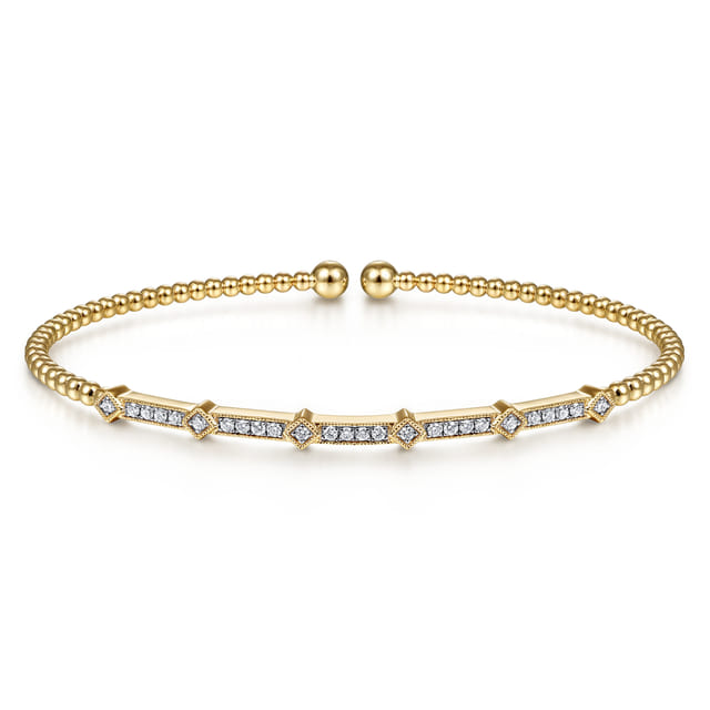 Gold bracelet with diamond accents on a white background