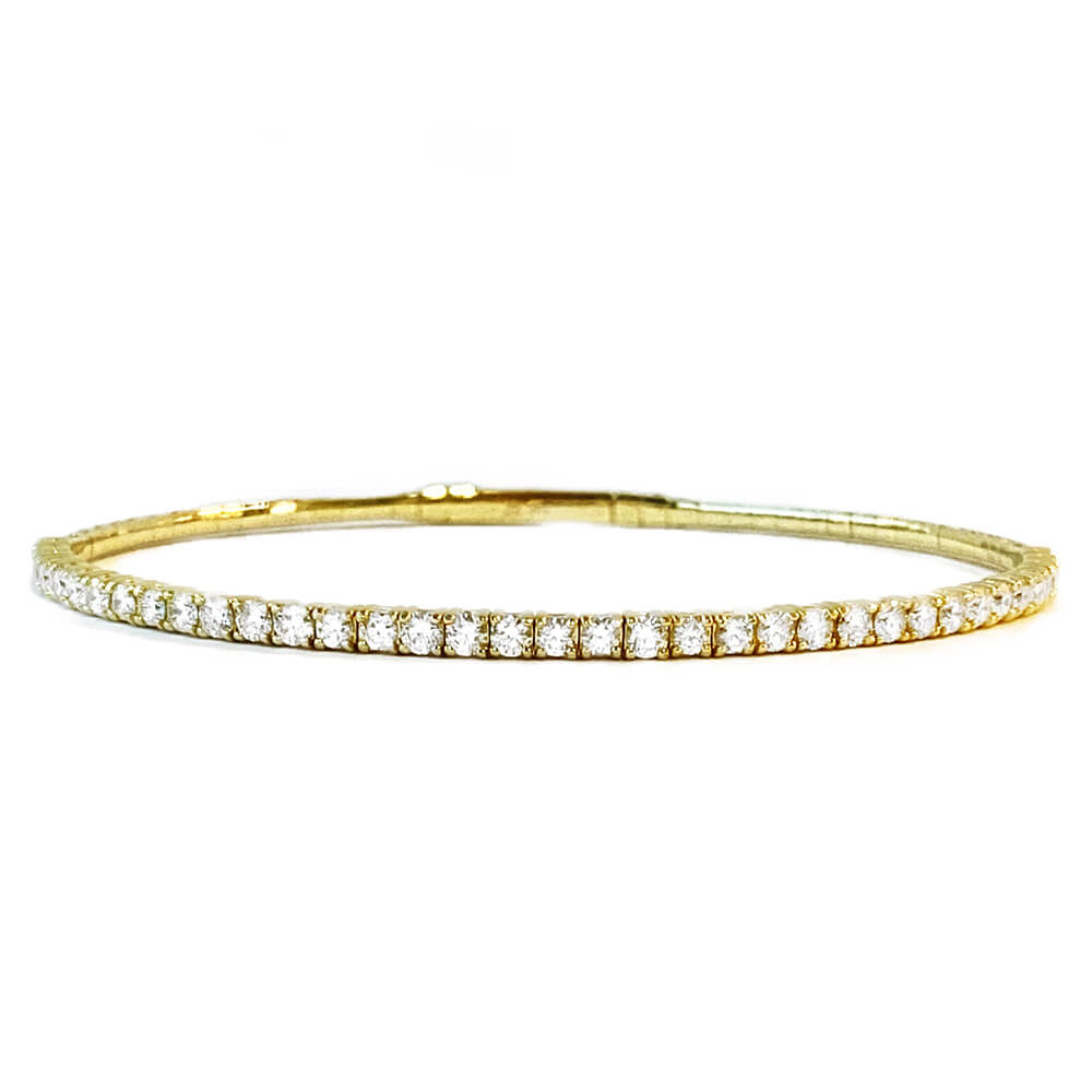 A 14k Yellow Gold Diamond Flexible Bangle with multiple diamonds