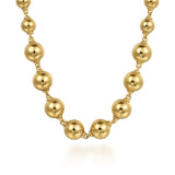 A gold beaded necklace with large, polished spherical beads connected by delicate chain links, shown on a clean white background.