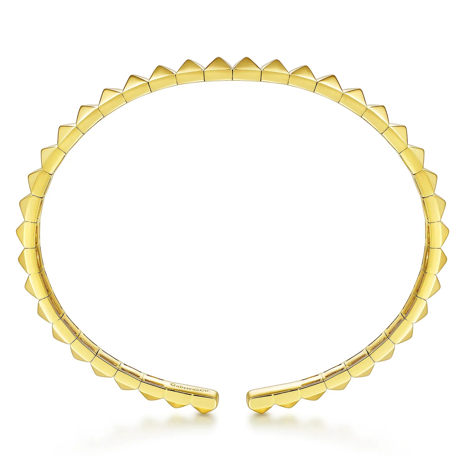 A 14K gold open cuff bracelet designed by Gabriel & Co