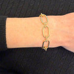 14K Gold Gabriel & Co. bracelet on a wrist against a black background