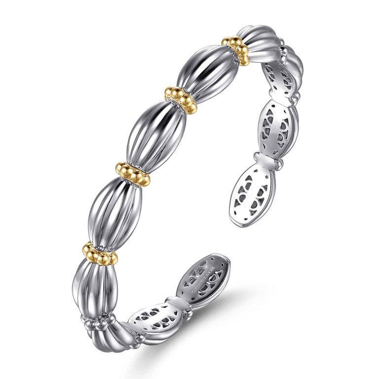 A sterling silver bangle bracelet with a segmented, ribbed design and small 14K gold bead accents, shown on a clean white background.