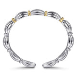 A sterling silver bangle bracelet with a segmented, ribbed design and small 14K gold bead accents, shown on a clean white background.