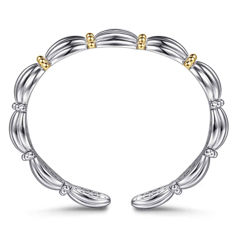 A sterling silver bangle bracelet with a segmented, ribbed design and small 14K gold bead accents, shown on a clean white background.