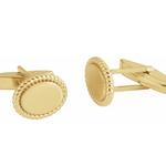 A pair of 14K yellow gold rope pattern cufflinks with a polished finish.