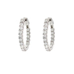 Pair of diamond hoop earrings on a white background
