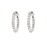 Pair of diamond hoop earrings on a white background