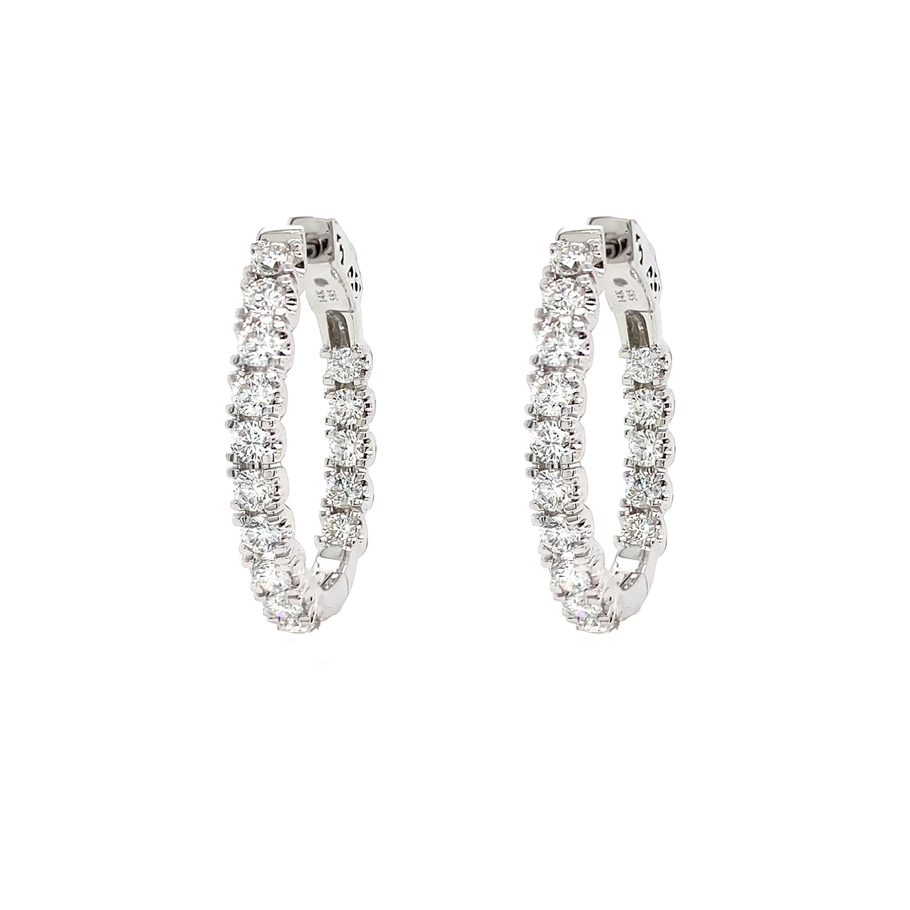 Pair of diamond hoop earrings on a white background