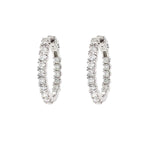A pair of 14K white gold diamond hoop earrings paved with round clear diamonds, shown against a plain white background.