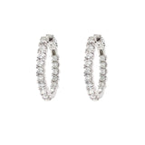 A pair of 14K white gold diamond hoop earrings paved with round clear diamonds, shown against a plain white background.