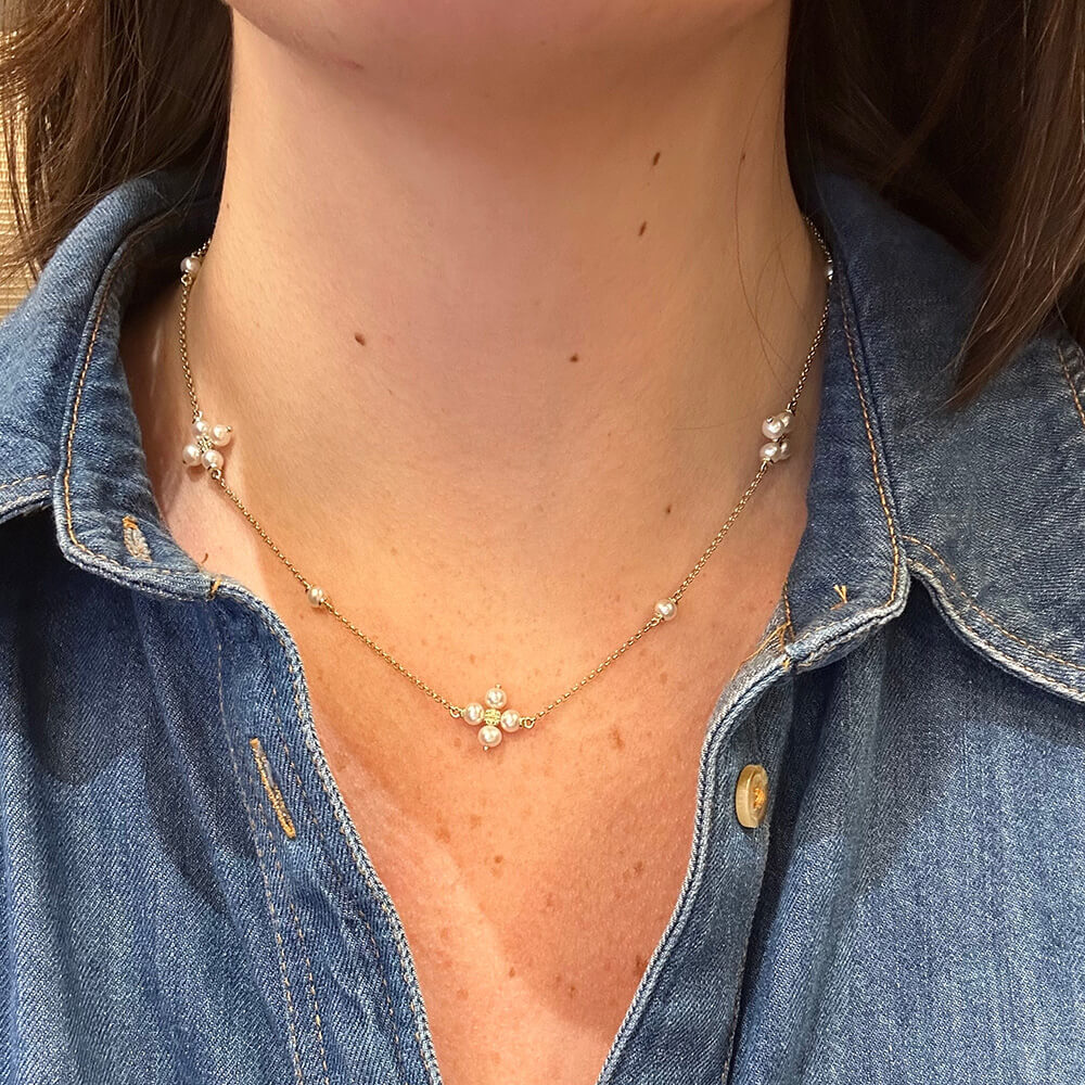 Woman wearing 14K gold necklace with Quad Pearl designs