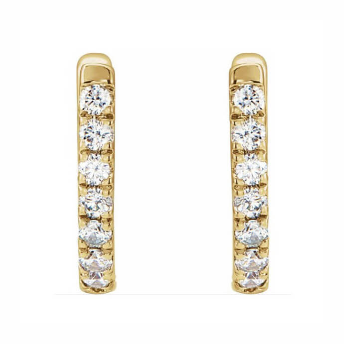 A pair of 14K gold huggie hoop earrings with diamonds