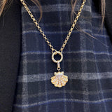 14K Gold necklace with a shell pendant on a blue plaid fabric background