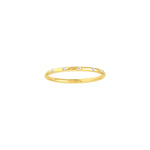 A thin yellow gold band ring with diamond stations, displayed against a white background.
