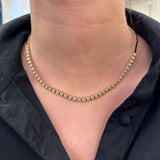 woman wearing 14k gold diamond bezel choker necklace