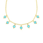 Gold necklace with turquoise stones on a white background