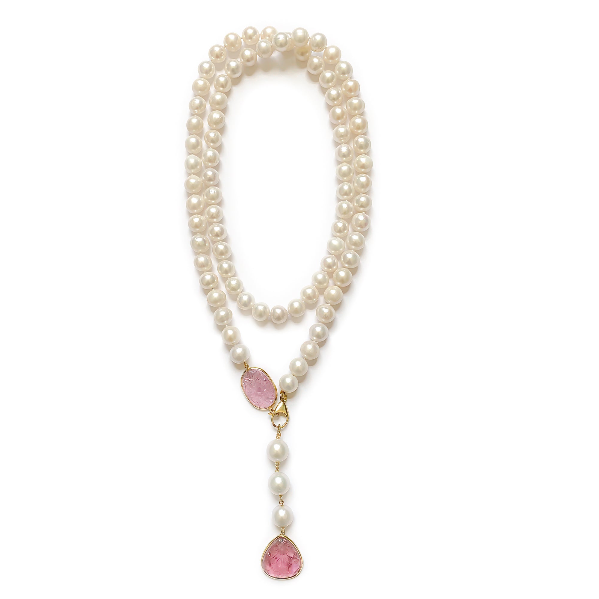 Pearl necklace with pink gemstone drop stones on a white background