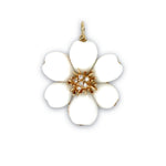 A 14K yellow gold pendant with a white coral flower design and diamond accents.
