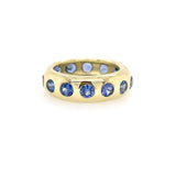 A 14K yellow gold sapphire dome ring with multiple blue sapphires set around its circumference.