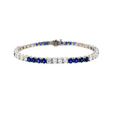 Bracelet with blue sapphire gemstones and diamonds on a white background