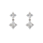 Pair of 14K white gold earrings with clover-shaped diamond designs on a white background